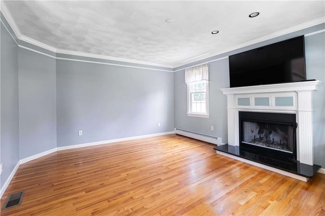 5 Victoria Lane Rehoboth, MA 02769 - Photo 23 of 48 Straddled between the staircase is the front formal living room.
