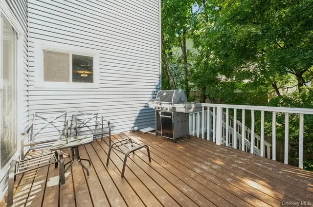 a view of a balcony with wooden floor and fence