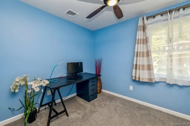 a workspace with furniture and a window