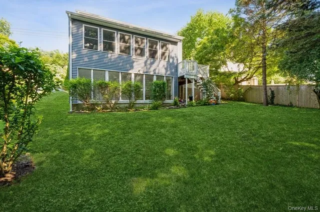 a view of a house with a yard and sitting area