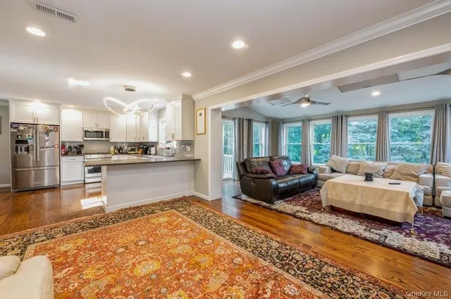 a living room with kitchen island furniture and a wooden floor