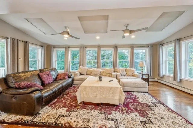 a living room with furniture and large windows