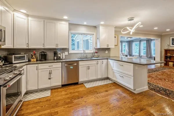 a kitchen with a sink stove and cabinets