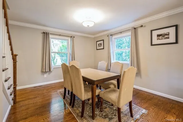 a view of a dining room with furniture window and wooden floor