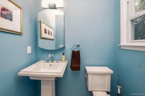 a bathroom with a toilet sink and mirror