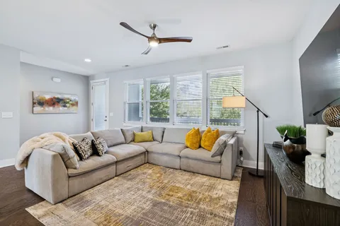 a living room with furniture and a chandelier