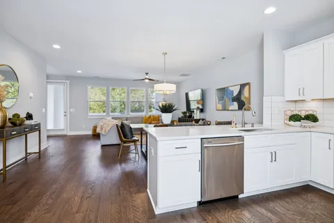 a view of living room with granite countertop furniture and a chandelier