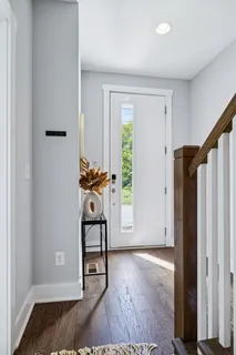a view of entryway and hall with wooden floor