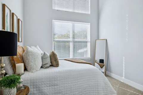 a bedroom with a bed and a window