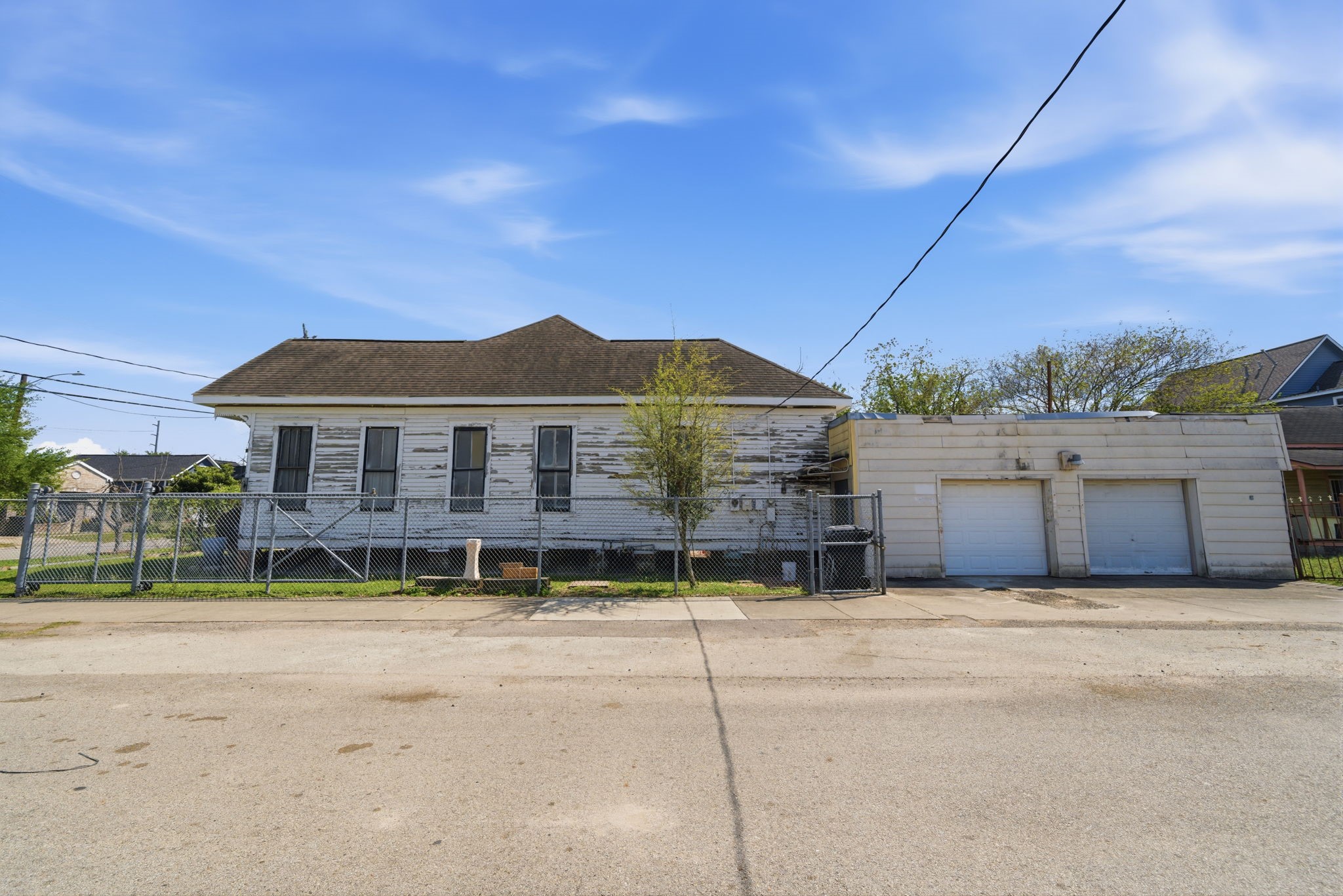 2023 Everett Street Houston, TX 77009 - Photo 22 of 25 Side view of 2023 Everett - she's highly raised off the ground, making her stand out even more on this corner of Near Northside. 7 min walk to Metro Rail Line, 10 min drive to Downtown Houston!