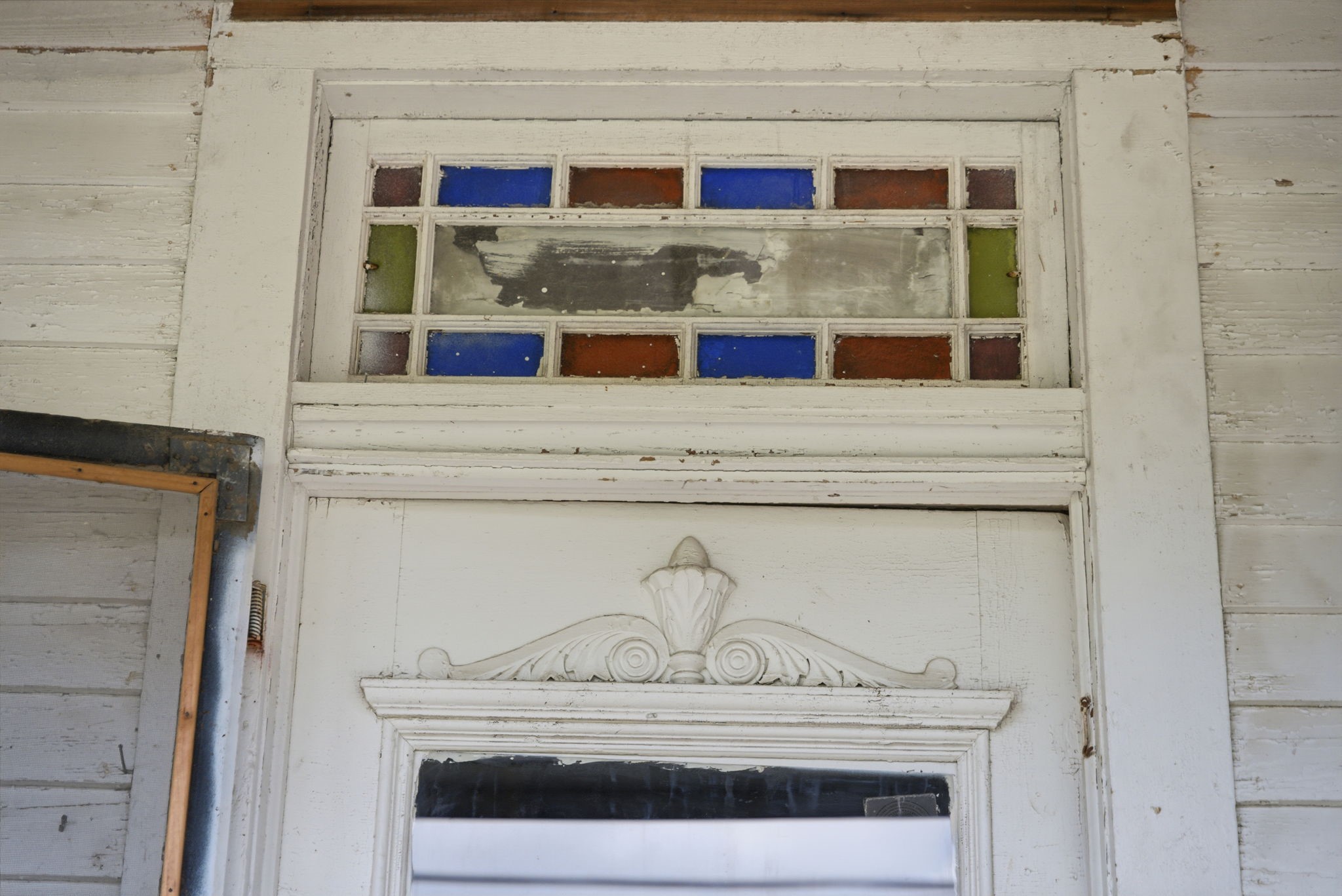 2023 Everett Street Houston, TX 77009 - Photo 6 of 25 With some elbow grease, the colored glass in the transom window will shine again!