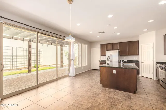 a large kitchen with cabinets and stainless steel appliances