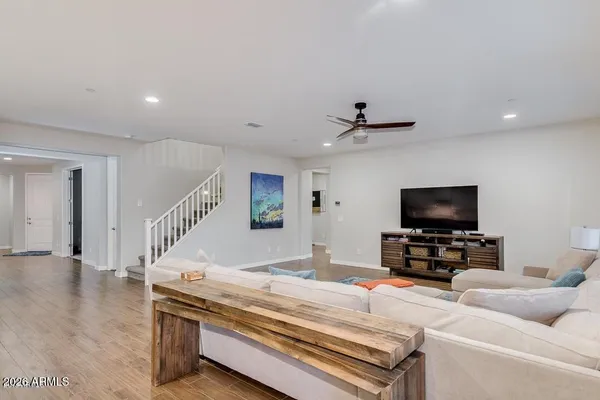 a kitchen with a table chairs and flat screen tv