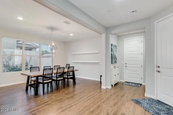 a view of a dining room with furniture and wooden floor
