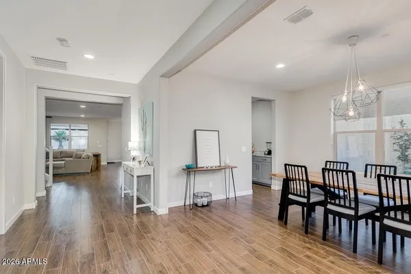 a kitchen with stainless steel appliances granite countertop a sink a stove a refrigerator and white cabinets