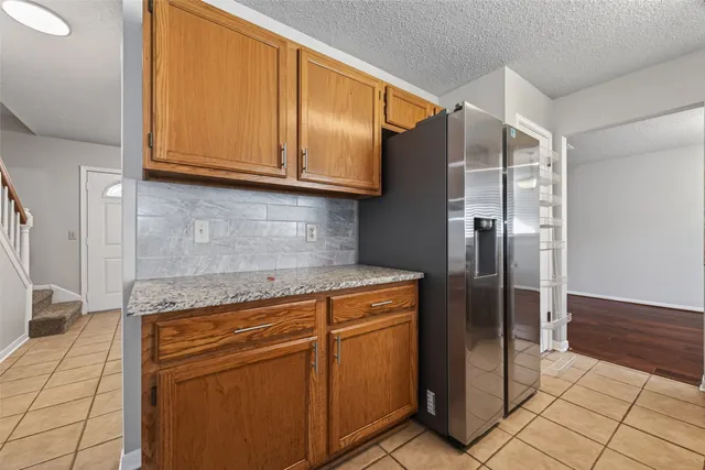 a kitchen with stainless steel appliances granite countertop a refrigerator and a stove