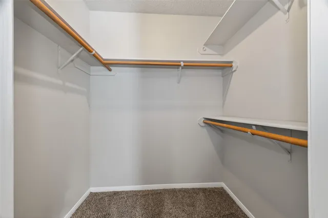 a bathroom with a granite countertop toilet sink and mirror