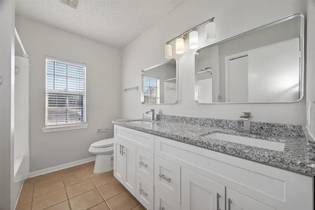 a bathroom with a tub and a window
