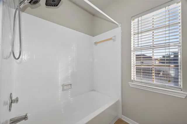 a view of an empty room with a ceiling fan