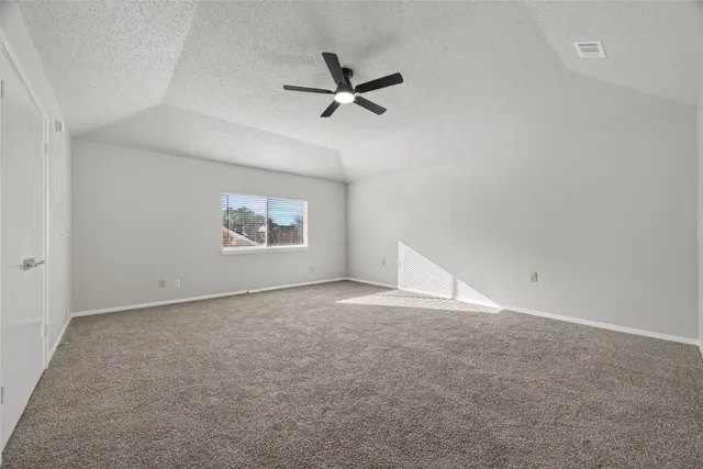 a view of a livingroom with a ceiling fan and window