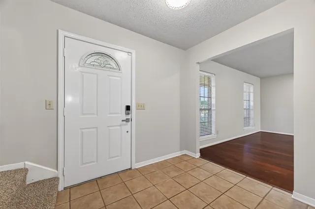 an empty room with wooden floor and mirror