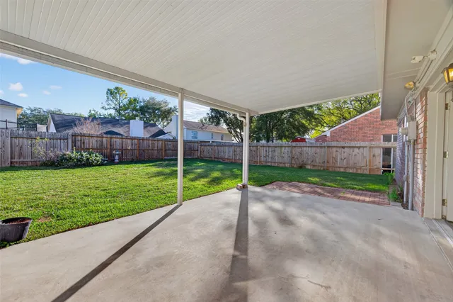 a view of an house with backyard and balcony