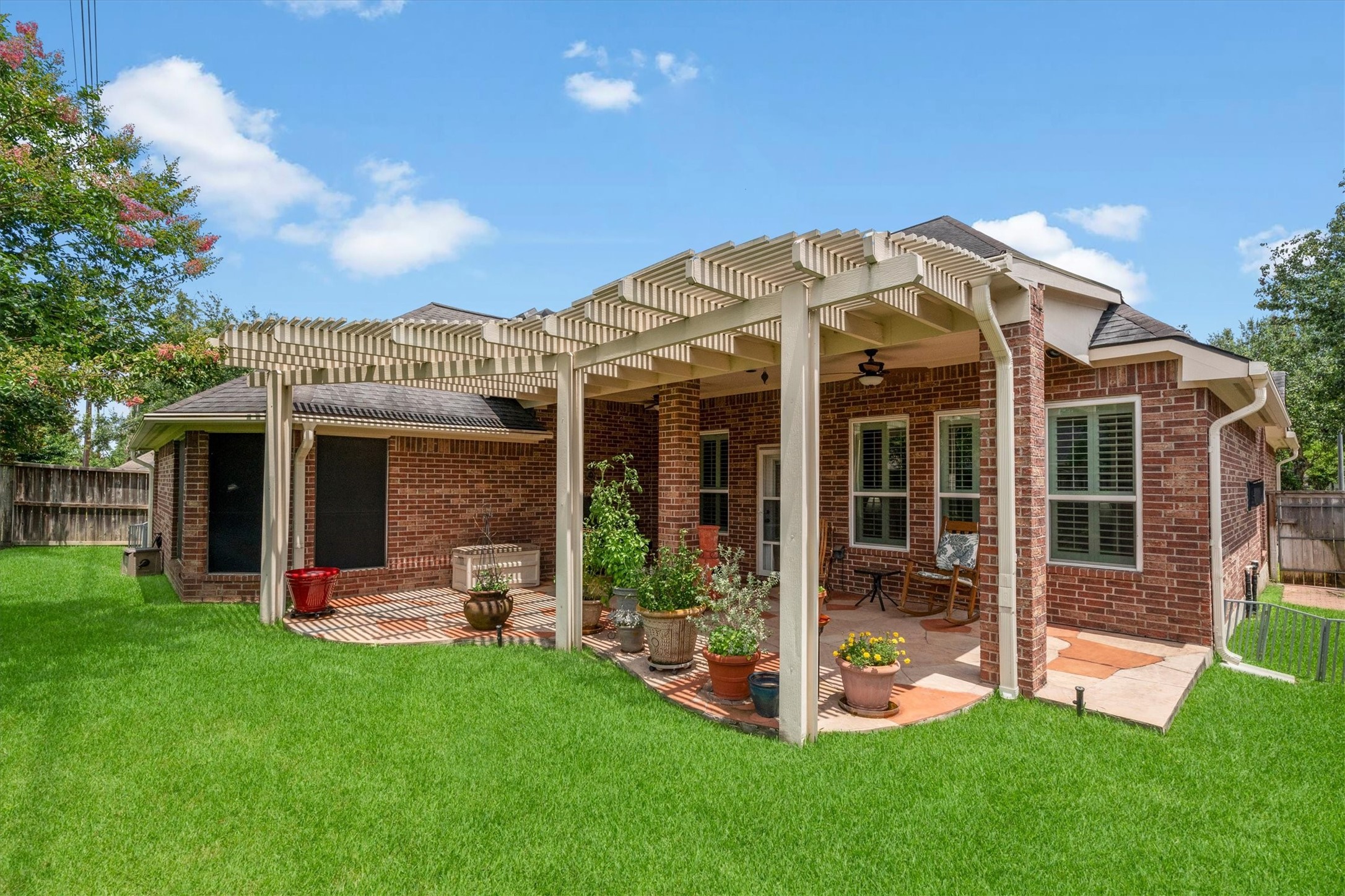 9406 Lochflora Drive Spring, TX 77379 - Photo 33 of 49 a view of a house with backyard porch and sitting area