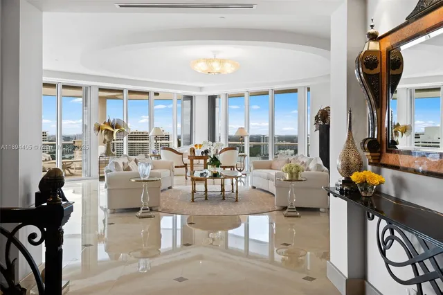 a living room with fireplace furniture and a large window