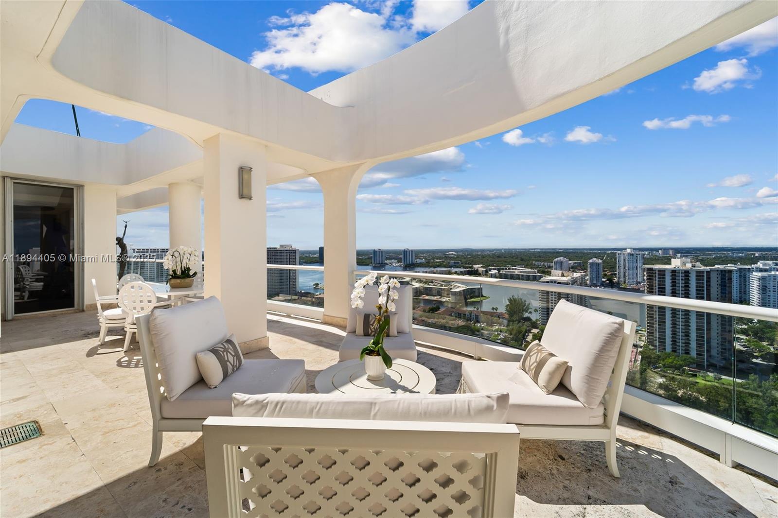 7000 Island Boulevard, Unit PH02 Aventura, FL 33160 - Photo 12 of 53 a living room with patio furniture and a potted plant