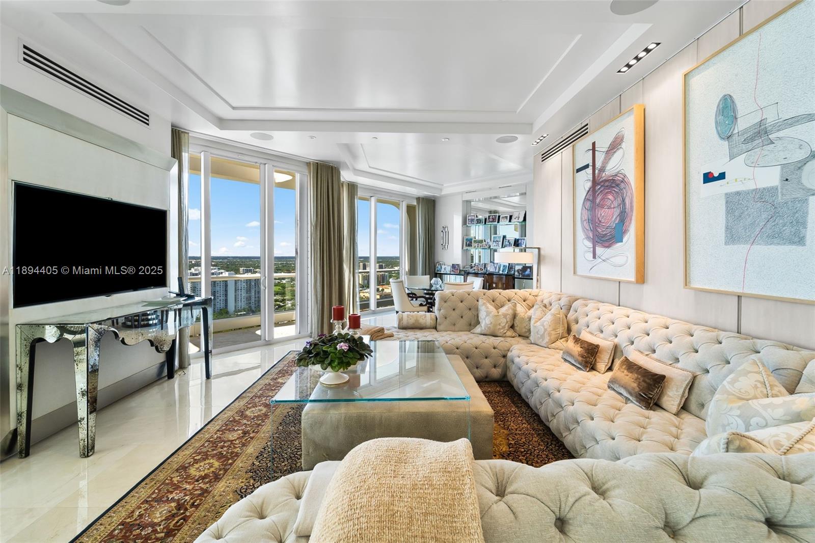 7000 Island Boulevard, Unit PH02 Aventura, FL 33160 - Photo 15 of 53 a living room with furniture and a flat screen tv