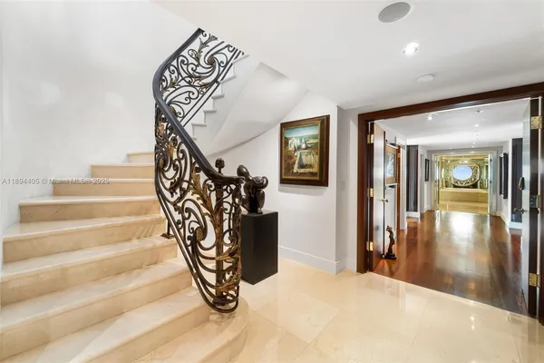 a view of a hallway with wooden floor and furniture