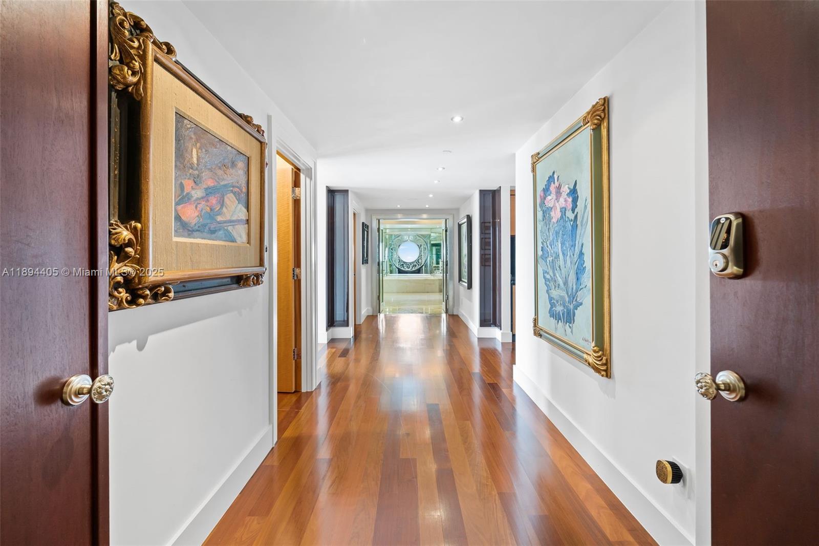 7000 Island Boulevard, Unit PH02 Aventura, FL 33160 - Photo 19 of 53 a view of a hallway with wooden floor and furniture