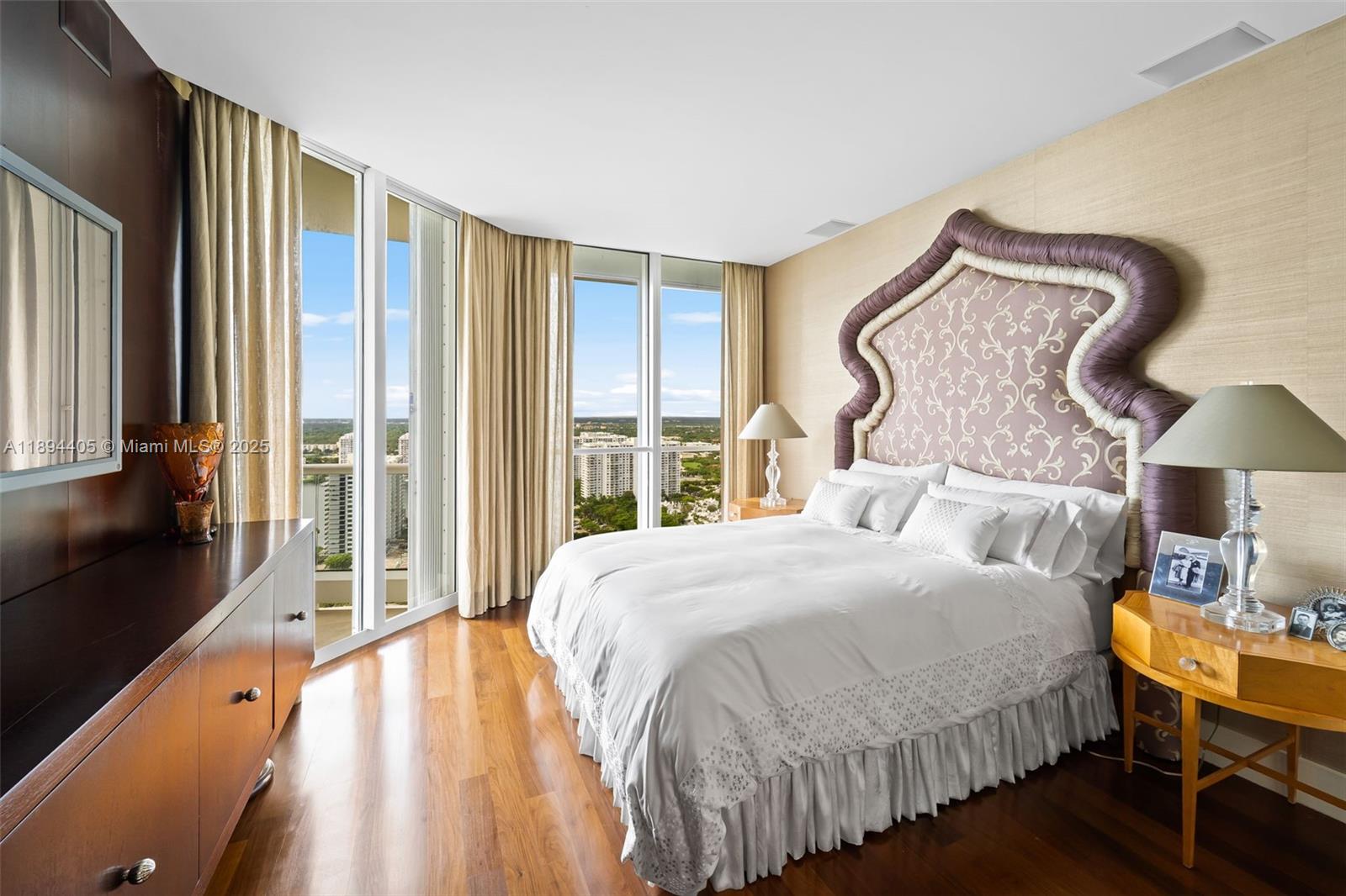 7000 Island Boulevard, Unit PH02 Aventura, FL 33160 - Photo 24 of 53 a bedroom with a bed and a lamp on table next to a window