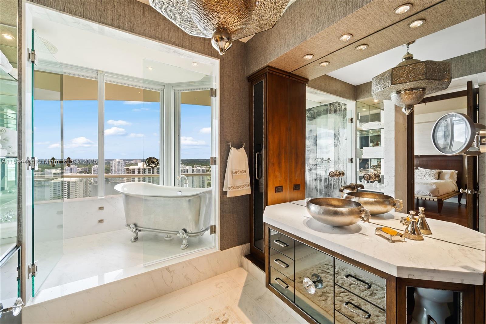 7000 Island Boulevard, Unit PH02 Aventura, FL 33160 - Photo 29 of 53 a kitchen with a sink and a stove next to a window