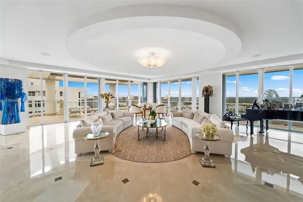 a living room with furniture and a dining table with kitchen view