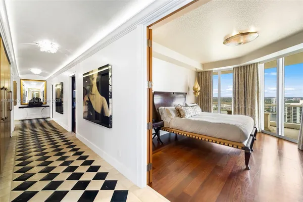 a bedroom with a bed and glass window