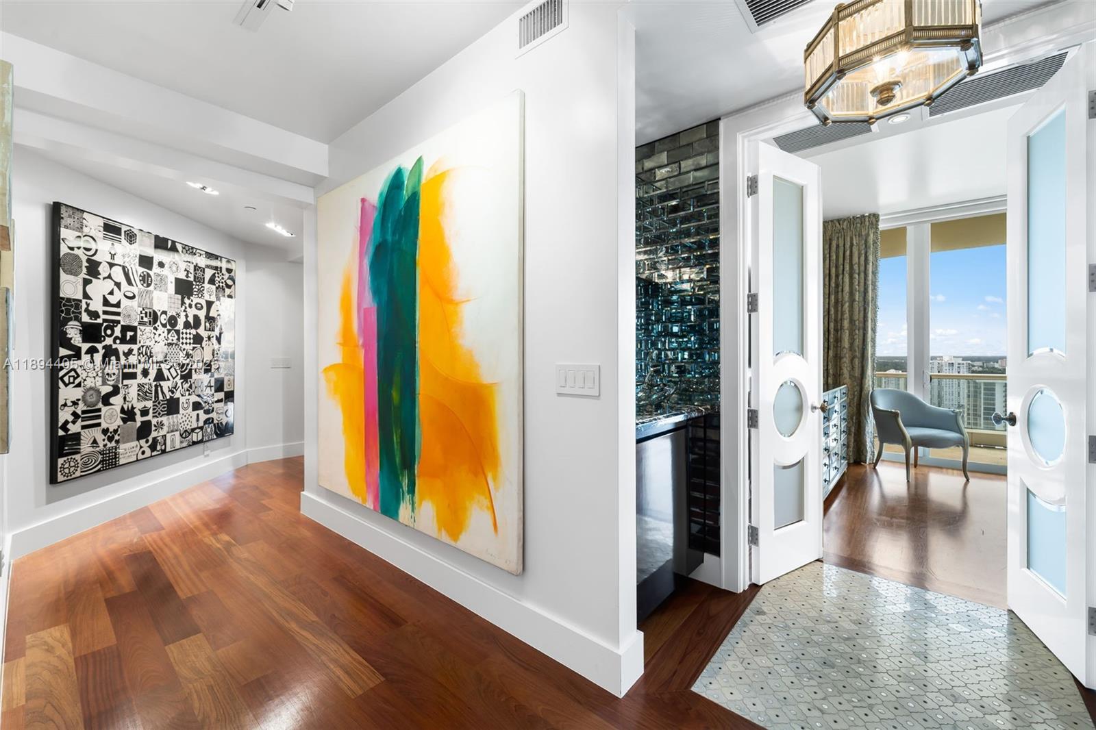 7000 Island Boulevard, Unit PH02 Aventura, FL 33160 - Photo 32 of 53 a view of a hallway with wooden floor and windows
