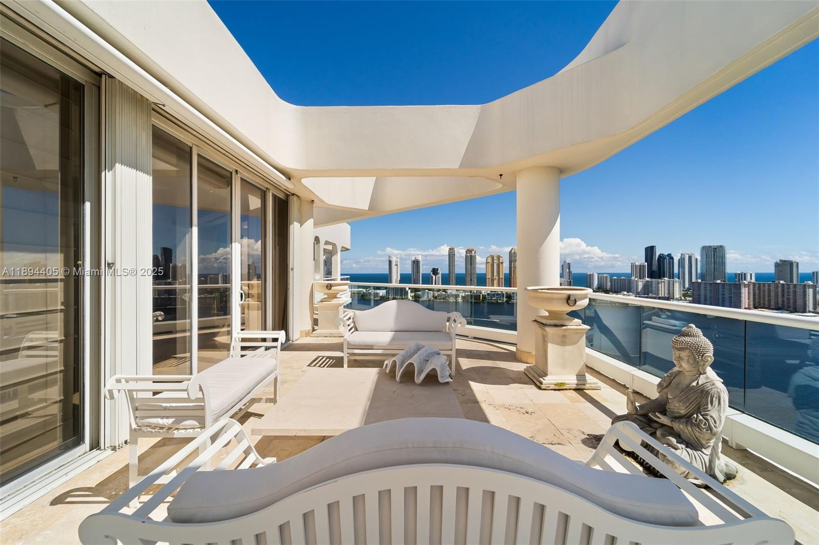 7000 Island Boulevard, Unit PH02 Aventura, FL 33160 - Photo 37 of 53 a view of a living room and kitchen