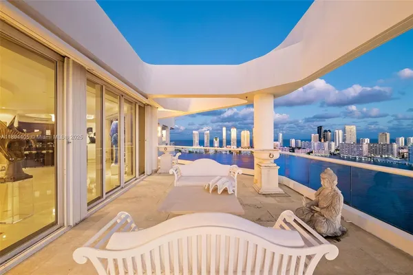 a view of a living room with furniture and floor to ceiling window