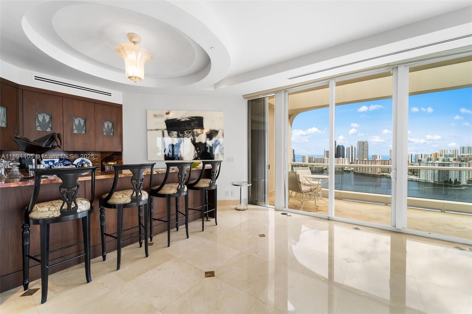 7000 Island Boulevard, Unit PH02 Aventura, FL 33160 - Photo 4 of 53 a living room with lots of furniture and a chandelier