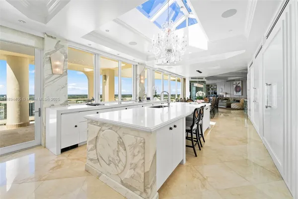a large white kitchen with a large window