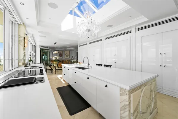 a large white kitchen with a large window