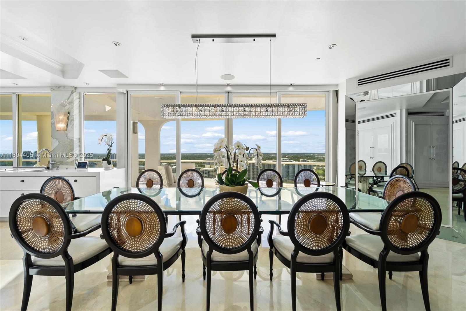 7000 Island Boulevard, Unit PH02 Aventura, FL 33160 - Photo 10 of 53 a view of a kitchen with furniture and windows