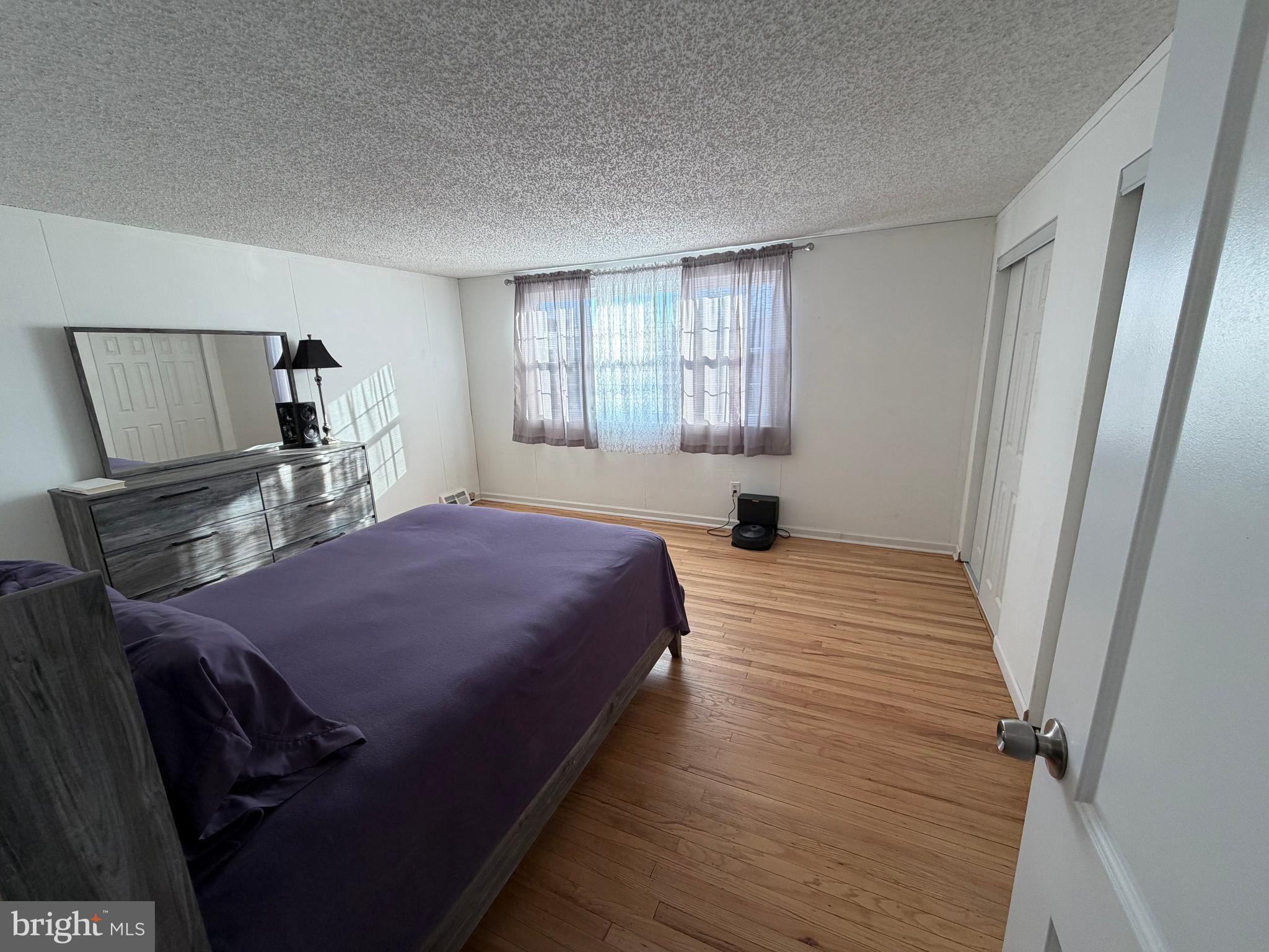 10916 Modena Place Philadelphia, PA 19154 - Photo 20 of 42 a bedroom with a bed and wooden floor