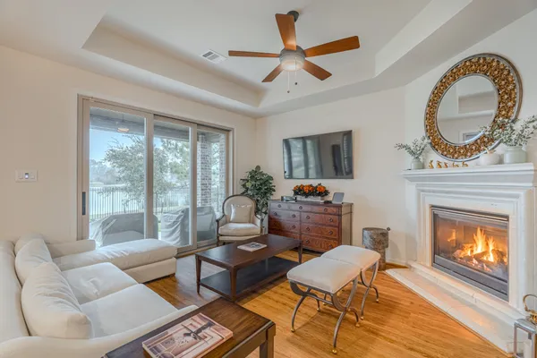 a living room with furniture a fireplace and a large window