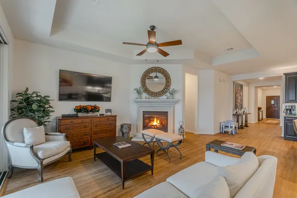 a living room with furniture a flat screen tv and a fireplace