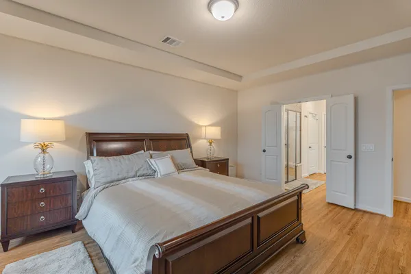 a bedroom with a bed and a lamp