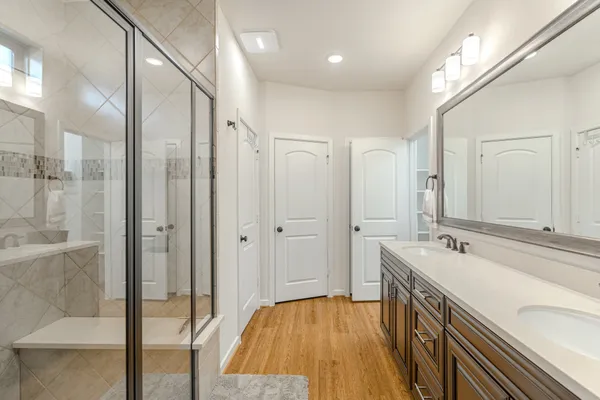 a bathroom with a sink a mirror and a shower