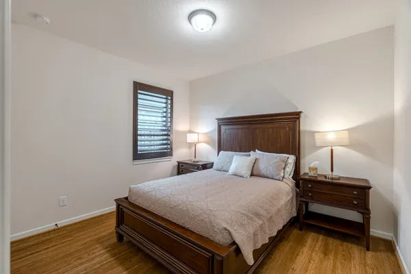 a bedroom with a bed and a night stand