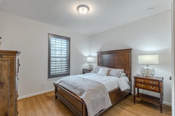 a bedroom with a bed and a night stand